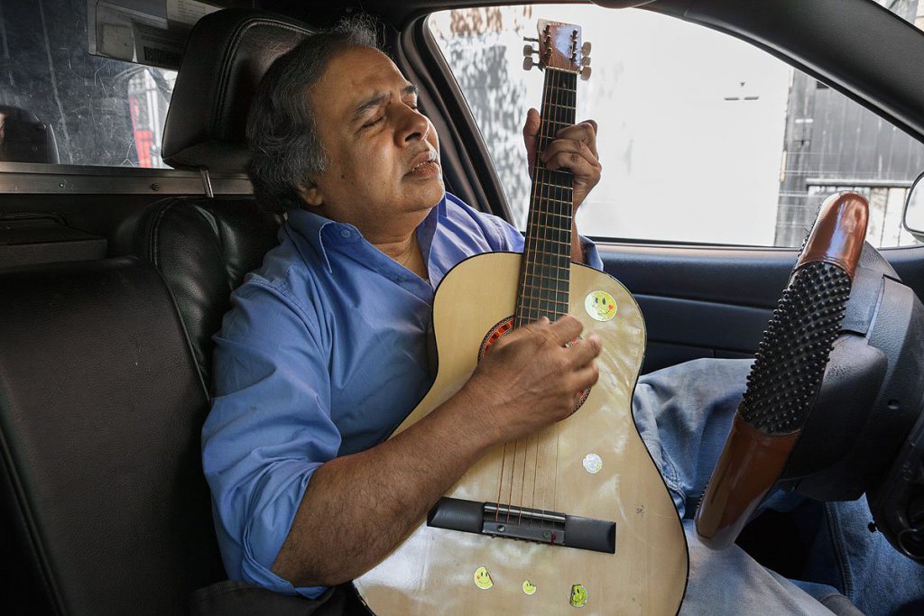 huda-monirul-is-from-bangladesh-he-always-brings-his-guitar-with-him-in-the-cab-so-he-can-play-during-his-break